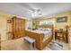 Bedroom features yellow walls, wood furniture, and a comfortable wicker bed at 120 Sand Dunes Dr, Ormond Beach, FL 32176