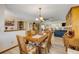 Charming dining area with wooden table, decorative chandelier and wicker furniture at 120 Sand Dunes Dr, Ormond Beach, FL 32176