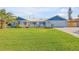 Charming home featuring a lush front lawn, white picket fence and a two-car garage at 120 Sand Dunes Dr, Ormond Beach, FL 32176