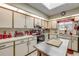 Bright kitchen with white cabinets, skylight, and island countertop at 120 Sand Dunes Dr, Ormond Beach, FL 32176
