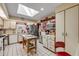 Bright kitchen with white cabinets, skylight, stainless steel appliances and red accents at 120 Sand Dunes Dr, Ormond Beach, FL 32176