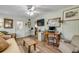 Bright living room with light brick walls, hard wood floors, and a comfortable seating area at 120 Sand Dunes Dr, Ormond Beach, FL 32176