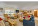 Open concept living room with comfortable couches, wicker chairs and lots of light at 120 Sand Dunes Dr, Ormond Beach, FL 32176