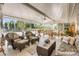 Bright sunroom features dining and seating areas with outdoor views at 120 Sand Dunes Dr, Ormond Beach, FL 32176