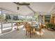 Open sunroom with tile floor and views of the backyard garden at 120 Sand Dunes Dr, Ormond Beach, FL 32176