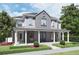 Charming two-story home with a covered porch, manicured landscaping, and gray accents at 1244 Water Maple Dr, Oakland, FL 34787