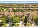 Beautiful aerial view of a residential area showing roof tops, trees, and well maintained streets on a sunny day at 1405 Thunderbird Rd, Davenport, FL 33896