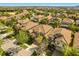 Attractive aerial view of a residential neighborhood featuring manicured lawns, tiled roofs, and tree-lined streets at 1405 Thunderbird Rd, Davenport, FL 33896