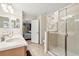 Bathroom featuring a glass shower, a double sink and an adjacent bedroom with nautical decor at 1405 Thunderbird Rd, Davenport, FL 33896
