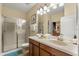 Bathroom features a double sink vanity, walk-in shower, and access to an adjacent bedroom for convenience at 1405 Thunderbird Rd, Davenport, FL 33896