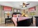 Well-appointed bedroom features a dark wood bed frame, decorative pillows, and stylish bedside lamps for a cozy ambiance at 1405 Thunderbird Rd, Davenport, FL 33896