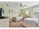 Bedroom showcasing two twin beds with coastal-themed decor and sea-inspired artwork at 1405 Thunderbird Rd, Davenport, FL 33896