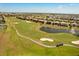 Panoramic aerial view of the golf course with water features and homes in a beautiful Florida community at 1405 Thunderbird Rd, Davenport, FL 33896