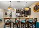 Modern kitchen with granite countertops, an island with seating, and stainless steel appliances at 1405 Thunderbird Rd, Davenport, FL 33896