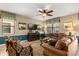 Comfortable living room featuring plush sofas, a ceiling fan, and stylish decor with coordinated colors at 1405 Thunderbird Rd, Davenport, FL 33896