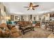 Spacious open-concept living room with tile floors, a ceiling fan, and comfortable seating arrangements at 1405 Thunderbird Rd, Davenport, FL 33896