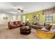 Spacious living room with comfortable seating, a ceiling fan, and ample natural light for a relaxed atmosphere at 1405 Thunderbird Rd, Davenport, FL 33896