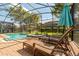 Inviting screened-in pool and spa area with lounge chairs for relaxation at 1405 Thunderbird Rd, Davenport, FL 33896