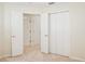 This bedroom features multiple doors and a closet with bi-fold doors at 14313 Roxshire Dr, Orlando, FL 32837