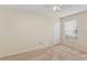 Bright bedroom features neutral carpet, ceiling fan and window for natural light at 14313 Roxshire Dr, Orlando, FL 32837