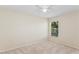 Cozy bedroom with a ceiling fan and window overlooking the yard at 14313 Roxshire Dr, Orlando, FL 32837