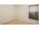 Beige carpeted bedroom featuring a window with blinds for natural light at 14313 Roxshire Dr, Orlando, FL 32837