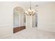 Dining room featuring neutral carpet and flooring, chandelier, and archway leading to other rooms at 14313 Roxshire Dr, Orlando, FL 32837