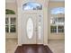 Bright foyer with wood floors, a decorative front door with glass, and sidelight windows at 14313 Roxshire Dr, Orlando, FL 32837