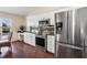 Modern kitchen with stainless steel appliances, granite countertops, white cabinets, and hardwood floors at 14313 Roxshire Dr, Orlando, FL 32837