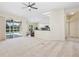 Bright living room open to kitchen, featuring a ceiling fan, sliding doors, and a view of the pool at 14313 Roxshire Dr, Orlando, FL 32837