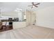 Inviting living room next to the kitchen, featuring a breakfast bar, neutral carpet, and lots of sunlight at 14313 Roxshire Dr, Orlando, FL 32837