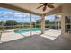 Covered patio showcasing a sparkling pool with a screened enclosure and scenic views at 14313 Roxshire Dr, Orlando, FL 32837