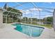 Sparkling screened-in pool with view of the lake and backyard at 14313 Roxshire Dr, Orlando, FL 32837