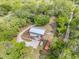 Aerial view showcases the property layout, with home, outbuildings, mature trees, and expansive lot at 145 Baywood Dr, Oak Hill, FL 32759