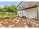 Landscaped backyard with trees, brick pavers, mulched ground cover, clothes line and a white building at 145 Baywood Dr, Oak Hill, FL 32759