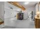 Spacious basement featuring ceiling fan and wooden beams, with storage cabinets and entry to another room at 145 Baywood Dr, Oak Hill, FL 32759