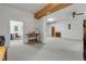 Basement featuring an exposed wooden beam, doorway, concrete floor, and an adjacent room at 145 Baywood Dr, Oak Hill, FL 32759