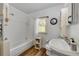 Clean bathroom with shower-tub combination and a vanity sink, plus wood-look floors and natural light at 145 Baywood Dr, Oak Hill, FL 32759