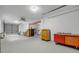Spacious garage with a ceiling fan, overhead lighting, workbench, cabinets, and painted concrete floor at 145 Baywood Dr, Oak Hill, FL 32759