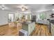Bright kitchen with wood-look floors, butcher block island, stainless steel appliances, and access to the dining area at 145 Baywood Dr, Oak Hill, FL 32759