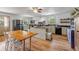 Spacious kitchen featuring wood-look floors, stainless steel appliances, butcher block island, and ample natural light at 145 Baywood Dr, Oak Hill, FL 32759