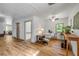 Living room with wood-look floors, large windows, ceiling fan and comfortable seating area at 145 Baywood Dr, Oak Hill, FL 32759