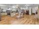 Open concept living space with wood-look floors, kitchen, dining and living areas with natural light at 145 Baywood Dr, Oak Hill, FL 32759
