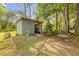 View of outbuilding with open bay and a small lawn in a parklike setting at 145 Baywood Dr, Oak Hill, FL 32759