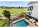 Aerial view featuring a private pool, patio area, and expansive golf course backdrop at 1539 Corolla Ct, Reunion, FL 34747
