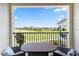 Balcony view showcasing lush golf course scenery, comfortable seating, and clear blue skies at 1539 Corolla Ct, Reunion, FL 34747