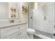 Modern bathroom featuring a granite vanity, decorative art and an oversized glass shower at 1539 Corolla Ct, Reunion, FL 34747