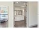 View of the bathroom entrance, showcasing its elegant vanity and open-concept design at 1539 Corolla Ct, Reunion, FL 34747