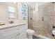 Well-lit bathroom featuring a glass shower, white vanity, and modern fixtures at 1539 Corolla Ct, Reunion, FL 34747