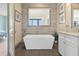 Modern bathtub with stylish fixtures, surrounded by elegant tile work and natural light at 1539 Corolla Ct, Reunion, FL 34747